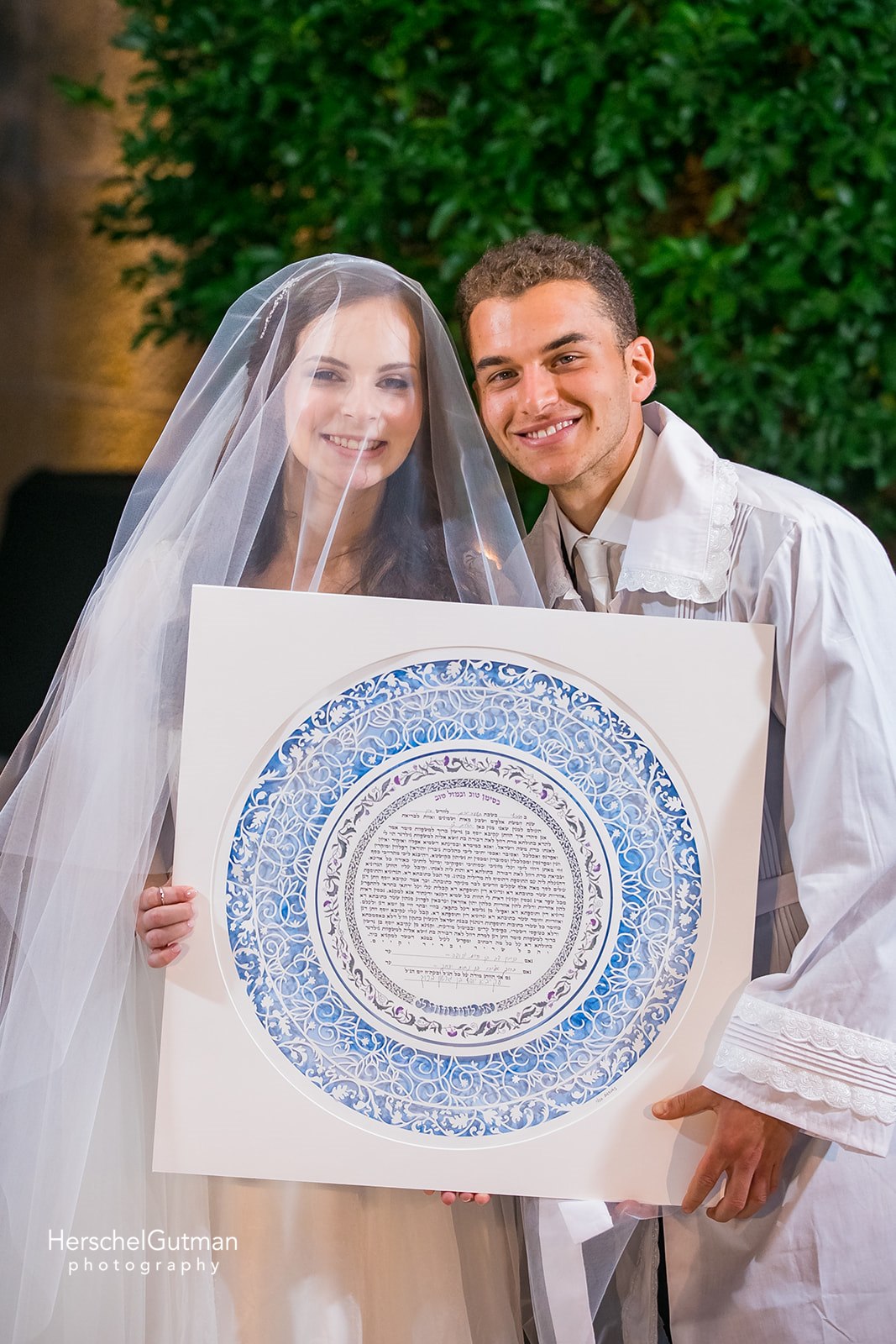 An emotional image of a couple reading their Ketubah, clearly moved by the promises within.